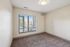 Bright and inviting bedroom with plush carpet and large window offering ample natural light.
