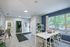 Bright and inviting apartment space featuring a cozy dining area with a large window, modern wall decor, and fresh design accents.