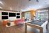 Contemporary lounge with multiple TVs, plush seating, modern lighting, and a sleek pool table.
