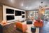Modern communal lounge with vibrant seating, multiple large screens, and elegant lighting, offering a stylish and inviting space for relaxation.