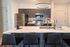 Modern kitchen with sleek cabinetry, stainless steel appliances, and elegant pendant lighting, perfect for culinary enthusiasts.