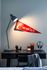 Cozy workspace with chic desk lamp, stylish headphones, and vibrant red pennant creating an inspiring study area.