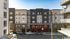 Modern urban apartment building with stylish facade and large windows, centrally located for ideal city living.