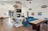 Elegant apartment lounge with modern fireplace, cozy furniture, and a game table, perfect for relaxation and entertainment.