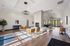 Elegant lobby area with contemporary seating, large windows, and a stylish fireplace, bathed in natural light.