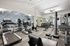 Modern fitness center with state-of-the-art exercise equipment, mirrored walls, and stylish interior design.