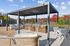 Chic outdoor patio area showcasing modern grill stations, comfortable seating, and scenic view of vibrant fall foliage.