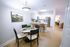 Contemporary open-plan kitchen and dining area with stylish decor, featuring sleek appliances and cozy seating arrangements.