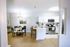 Bright, modern kitchen and dining area with sleek white cabinets, stainless steel appliances, and a cozy dining table perfect for entertaining.