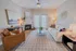 Inviting living room with elegant decor, cozy fireplace, and natural lighting flooding through large windows.