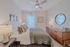 Bright, modern bedroom with elegant decor, stylish wooden furniture, and a cozy bed, perfect for relaxation.