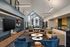 Modern and inviting lounge area with stylish seating, contemporary lighting, and a large window offering natural light.