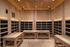 Luxurious wooden sauna room with ambient lighting and elegant benches, perfect for relaxation.