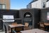 Chic outdoor area featuring a modern outdoor grill and pizza oven, perfect for alfresco dining and entertaining.
