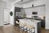 Contemporary kitchen with sleek cabinetry, state-of-the-art appliances, and an elegant island with seating, perfect for modern living.