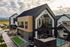 Modern architectural masterpiece with sleek design, large windows, and a cozy patio by the pool, set against a picturesque mountain backdrop.