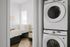 Modern apartment featuring a cozy bedroom with stylish decor next to a sleek in-unit laundry area.