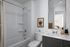 Elegant modern bathroom with sleek fixtures, a large mirror, and stylish decor.