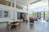Spacious and inviting modern living area with large windows, stylish seating, and elegant decor, perfect for relaxation and socializing.