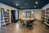 Inviting community snack lounge with modern seating, stocked shelves, and refrigerated beverage options.