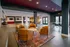 Elegant communal lounge with warm-toned seating, vibrant rug, and modern decor, ideal for social gatherings and relaxation.