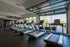 Modern fitness center with multiple treadmills and expansive windows offering scenic views.
