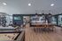Modern, open-concept apartment interior showcasing a spacious living area with sleek furnishings, a contemporary kitchen with stylish bar stools, and large windows offering ample natural light.
