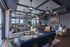 Luxurious lounge area with modern decor, featuring cozy seating, stylish lighting, and a large window view; ideal for social gatherings or relaxation.
