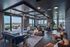 Chic modern living space with panoramic city views, featuring cozy seating areas and natural light.