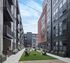 Modern urban courtyard featuring stylish apartment buildings with balconies, string lights, and a vibrant outdoor social space.