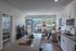 Inviting modern apartment featuring a cozy living room, sleek kitchen, and abundant natural light, perfect for relaxation and entertaining.