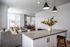 Elegant open-concept living space with modern gray sofa, chic pendant lighting, and stylish kitchen island.