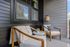 Charming balcony retreat with cozy chairs, warm wooden accents, and soft lighting, perfect for relaxing afternoons.