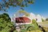 Charming Hunter's Ridge apartment complex with lush greenery and modern architecture under a clear blue sky.