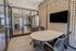 Modern office meeting room with sleek glass walls, stylish perforated paneling, and comfortable seating, perfect for productive collaboration.