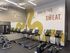 Modern fitness center with treadmills, ellipticals, and motivational wall art, perfect for an energizing workout.