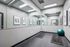 Modern fitness room with sleek mirrors, stylish artwork, yoga mats, and an exercise ball, perfect for a refreshing workout.