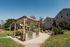 Charming apartment community with outdoor BBQ area, stylish pergola, and lush greenery, perfect for social gatherings.