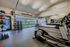 Modern apartment gym featuring state-of-the-art treadmills, free weights, and bright natural lighting through large windows.