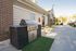 Inviting outdoor patio with a sleek grill, vibrant yellow seating, and a charming pergola for perfect entertaining.