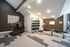 Modern home gym with sleek equipment, including treadmill, dumbbells, and exercise bench set against stylish decor and ambient lighting.
