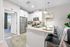 Modern kitchen design with sleek stainless steel appliances, inviting breakfast bar, and elegant white cabinetry, perfect for entertaining.