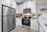 Modern kitchen with sleek stainless steel appliances, granite countertops, elegant white cabinetry, and stylish decor.