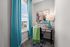 Charming home office nook with bright blue curtains, artistic wall art, and a sleek desk featuring modern decor.
