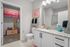 Modern bathroom with elegant granite countertop, vibrant decor, and spacious walk-in closet, perfect for luxury living.