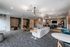 Modern communal lounge showcasing cozy seating areas, stylish bar stools, and a sleek entertainment setup with vibrant decor and ambient lighting.
