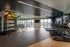 Modern fitness center with state-of-the-art treadmills, free weights, and vibrant exercise balls, featuring expansive windows for natural light.