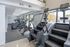 Contemporary fitness center with advanced gym equipment and large windows for natural light.