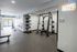 Modern fitness center with stylish equipment, motivational 'Don't Quit' sign, and bright open space.