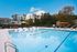 Inviting outdoor pool area at Terrace View Apartments, featuring lounge chairs, vibrant umbrellas, and a refreshing atmosphere.